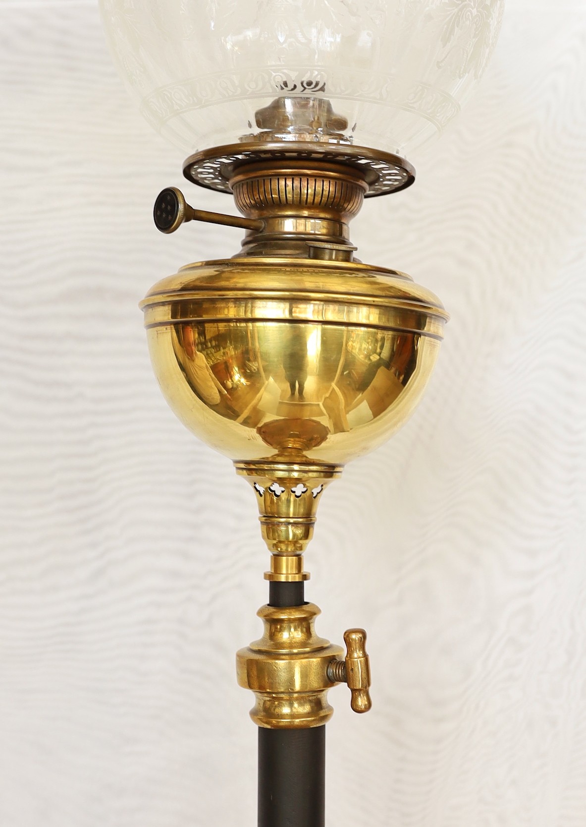 A late Victorian wrought iron brass and copper telescopic oil lamp standard with etched glass shade and flue, height overall 159cm